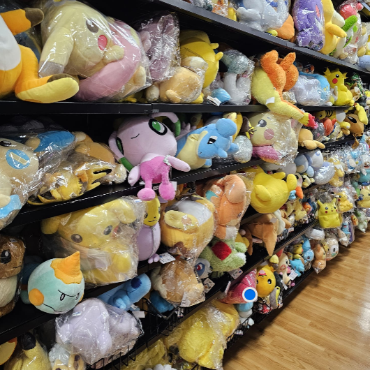 A display of various Pokémon plush toys on shelves.